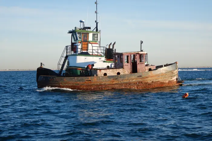 An old-looking tugboat on the sea
